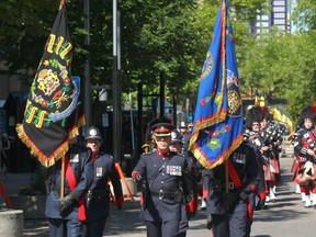 Calgary Police Service color guard approach city hall during ceremonies in Calgary on Sunday July 2, 2017 in front of City Hall marking the 100 year anniversary of the death of the first Calgary Police officer killed in the line of duty. Constable Arthur Duncan was killed July 2 1917. Before Duncan had a chance to draw his weapon, he was shot in the jaw and chest with a Colt .45 revolver. Jim Wells//Postmedia