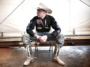 Tanner Byrne wears Ty Pozzobon's boots at the Calgary Stampede. Leah Hennel/Postmedia