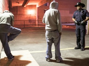 Sgt. Chris Ogwal of the downtown beat unit takes part in Operation Don't Go Chasing Waterfalls, a pre-Stampede crime sweep of the downtown core.