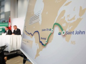 TransCanada Corp. president and CEO Russ Girling, right, speaks at the company's announcement of an Energy East Pipeline project on Aug. 1, 2013, in this file photo.