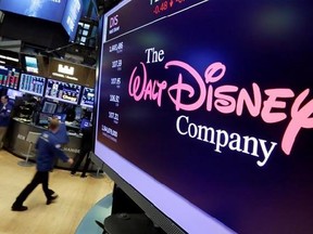 In this Monday, Aug. 7, 2017, photo, The Walt Disney Co. logo appears on a screen above the floor of the New York Stock Exchange. The Walt Disney Co. reports earnings, Tuesday, Aug. 8, 2017. (AP Photo/Richard Drew)