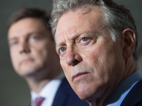 B.C. Environment Minister George Heyman, front, and Attorney General David Eby listen to a question during a news conference about the Kinder Morgan Trans Mountain pipeline expansion project, in Vancouver, B.C., on Thursday August 10, 2017.