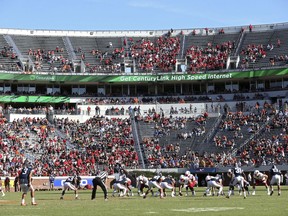 FILE - In this Oct. 29, 2016, file photo, Louisville lines up for a play against Virginia during an NCAA college football game in Charlottesville, Va. ESPN broadcaster Robert Lee will not work Virginias season opener because of recent violence in Charlottesville sparked by the decision to remove a statue of Confederate Gen. Robert E. Lee. A spokeswoman for ESPN says Lee has been moved to Youngstown States game at Pittsburgh on the ACC Network on Sept. 2. The network says the decision was made as the tragic events in Charlottesville were unfolding, simply because of the coincidence of his name. (AP Photo/Ryan M. Kelly, File)