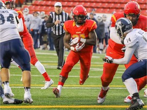 U of C Dinos Jeshrun Antwi makes a run for a touchdown against the St. Francis X-Men in Mitchell Bowl action at McMahon Stadium in Calgary, Alta.. on Nov. 19, 2016.