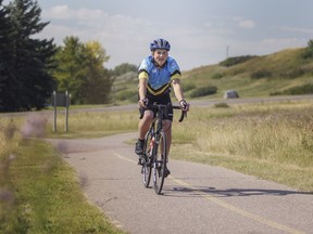 Adam Sorenson, 17, rides his bike down a path in Calgary's Fish Creek Park on Thursday, August 10, 2017. Sorenson, who has brain cancer but it is in remission, is riding in the Enbridge Ride to Conquer Cancer this weekend with his family. Kerianne Sproule/Postmedia