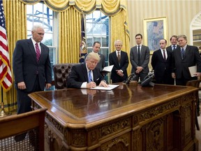 President Donald Trump's signs an executive order in January in the Oval Office surrounded by his then inner circle: from left to right: Vice-President Mike Pence; White House Chief of Staff Reince Preibus; Peter Navarro, Director of the National Trade Council; Jared Kushner, Senior Advisor to the President; Steven Miller, Senior Advisor to the President; unknown; and Steve Bannon, White House Chief Strategist. 

(AFP OUT)
Pool, Getty Images