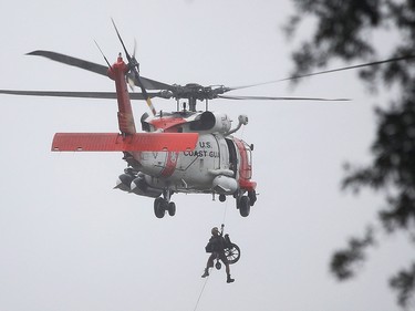 HOUSTON, TX - AUGUST 28:  A Coast Guard helicopter hoists a wheel chair on board after lifting a person to safety  from the area that was inundated with flooding from Hurricane Harvey on August 28, 2017 in Houston, Texas. Harvey, which made landfall north of Corpus Christi late Friday evening, is expected to dump upwards to 40 inches of rain in Texas over the next couple of days.  (Photo by Joe Raedle/Getty Images)