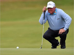 Mark O'Meara lines up a putt on the 8th green during his opening round on the first day of the Open Golf Championship at Royal Birkdale golf course near Southport in north west England on July 20, 2017.