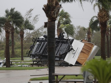 An overturned trailer sits in a park in the wake of Hurricane Harvey, Saturday, Aug. 26, 2017, in Aransas Pass, Texas.   Harvey rolled over the Texas Gulf Coast on Saturday, smashing homes and businesses and lashing the shore with wind and rain so intense that drivers were forced off the road because they could not see in front of them. (AP Photo/Eric Gay) ORG XMIT: TXEG108