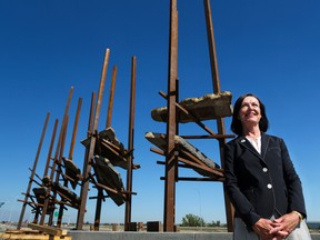 The City of Calgary's manager of arts and culture Sarah Iley stands near the Bowfort Towers art installation.
