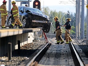 Calgary firefighters clean up after an SUV crashed onto the platform at the Sirocco CTrain station in Calgary on Sunday August 6, 2017. Gavin Young/Postmedia

Postmedia Calgary
Gavin Young, Gavin Young