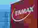 Powerlines rise behind an Enmax sign at the utility's head office in Calgary. 