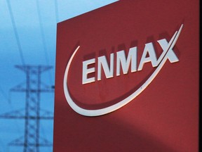 Powerlines rise behind an Enmax sign at the utility's head office in Calgary.