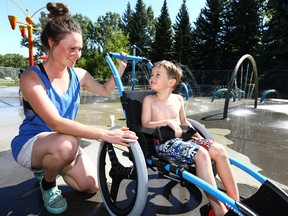 Marnie Jenkins, Pool Operator at the Canmore Wading Pool straps in Seth Brodoff,5, into one of the new aquatic wheelchairs wading pools in Calgary will now have on hand on Saturday August 26, 2017. Darren Makowichuk/Postmedia