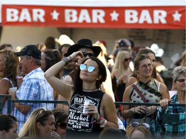 Fans enjoy a sunny day one of the Country Thunder music festival held at Prairie Winds Park Friday, August 18, 2017. Dean Pilling/Postmedia