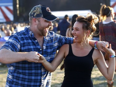 Fans dance as Dallas Smith performs on day one of the Country Thunder music festival held at Prairie Winds Park Friday, August 18, 2017. Dean Pilling/Postmedia