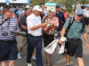 Fred Couples signs autographs for fans after finishing the RBC Pro Am on Thursday.