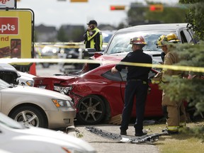 Emergency crews attend the scene of a fatal crash at the 130th Avenue S.E. Superstore parking lot in Calgary on Aug. 2, 2017.