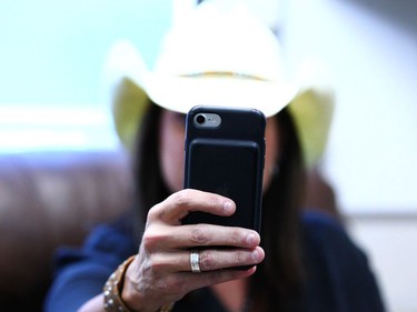 Canadian country artist Terri Clark takes a selfie with her phone in her dressing room before her set during day 2 of Country Thunder Music Festival in Calgary Saturday, August 19, 2017. Jim Wells/Postmedia