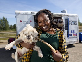 Nikita Scringer, owner of Pooch N Perks food truck and her dog Biggy Smalls at Sue Higgins park in Calgary on Friday August 25, 2017. Leah Hennel/Postmedia