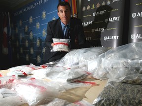 Staff Sgt. Garth Kowalyk with ALERT, poses with some of the drugs seized in Calgary last week.