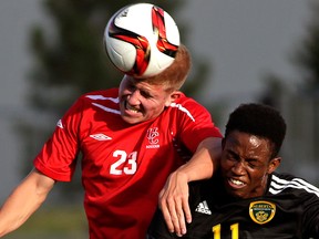 University of Calgary Dinos defender Jared Fillo (left) heads the ball beside University of Alberta Golden Bears forward Tolu Esan (right) during university soccer game action at Foote Field in Edmonton on Wednesday August 24, 2016. (Photo by Larry Wong/Postmedia)