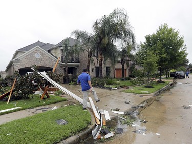 A contractor walks over debris from Hurricane Harvey Saturday, Aug. 26, 2017, in Missouri City, Texas.  Harvey rolled over the Texas Gulf Coast on Saturday, smashing homes and businesses and lashing the shore with wind and rain so intense that drivers were forced off the road because they could not see in front of them.  (AP Photo/David J. Phillip) ORG XMIT: TXDP104