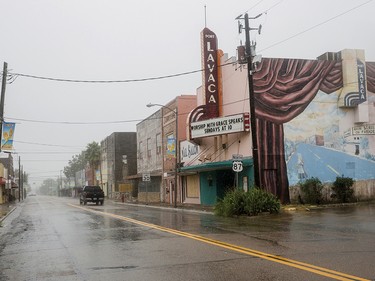 A single truck drives down a street as Hurricane Harvey makes landfall in downtown Port Lavaca, Texas on Friday, Aug. 25, 2017. Hurricane Harvey smashed into Texas late Friday, lashing a wide swath of the Gulf Coast with strong winds and torrential rain from the fiercest hurricane to hit the U.S. in more than a decade. (/The Victoria Advocate via AP) ORG XMIT: TXVIC506