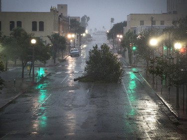 A tree blocks a street as Hurricane Harvey makes landfall in Corpus Christi, Texas, on Friday, Aug. 25, 2017. Hurricane Harvey smashed into Texas late Friday, lashing a wide swath of the Gulf Coast with strong winds and torrential rain from the fiercest hurricane to hit the U.S. in more than a decade.  (Nick Wagner /Austin American-Statesman via AP) ORG XMIT: TXAUS101