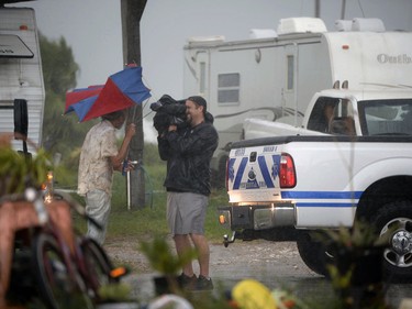 A Bolivar Peninsula resident holds his umbrella while being interviewed as Hurricane Harvey approaches the Texas coast Friday, Aug. 25, 2017 (Guiseppe Barranco/The Beaumont Enterprise via AP) ORG XMIT: TXBEA503