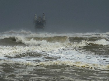 Larger than usual waves come ashore at Crystal Beach as Hurricane Harvey approaches Texas on Friday, Aug. 25, 2017 in Crystal Beach, Texas. Harvey intensified into a hurricane Thursday and steered for the Texas coast with the potential for up to 3 feet of rain, 125 mph winds and 12-foot storm surges in what could be the fiercest hurricane to hit the United States in almost a dozen years. (Guiseppe Barranco/The Beaumont Enterprise via AP) ORG XMIT: TXBEA107