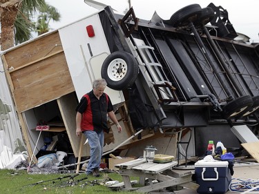 Todd Witherington searches his trailer that was overturned by the effects of Hurricane Harvey, Monday, Aug. 28, 2017, in Aransas Pass, Texas. (AP Photo/Eric Gay) ORG XMIT: TXEG125