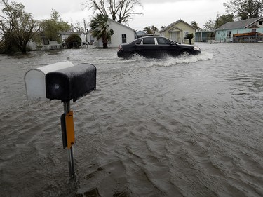 A drives moves through flood waters left behind by Hurricane Harvey, Saturday, Aug. 26, 2017, in Aransas Pass, Texas.  Harvey rolled over the Texas Gulf Coast on Saturday, smashing homes and businesses and lashing the shore with wind and rain so intense that drivers were forced off the road because they could not see in front of them. (AP Photo/Eric Gay) ORG XMIT: TXEG117