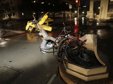 Wires are exposed after a traffic signal was snapped by the winds of Hurricane Harvey in downtown Corpus Christi, Texas, Saturday, Aug. 26, 2017. Harvey has been further downgraded to a Category 1 hurricane as it churns slowly inland from the Texas Gulf Coast, already depositing more than 9 inches of rain in South Texas. (AP Photo/Eric Gay) ORG XMIT: TXEG102