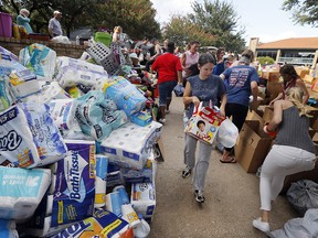 Stacks of donations are organized by volunteers after they were dropped off at the North Dallas location for Hurricane Harvey victims, Tuesday, Aug. 29, 2017.