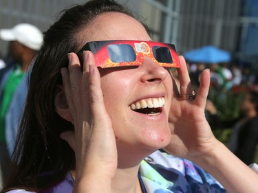 Melanie Hall, Public Programs Manager at Telus Spark, wears protective glasses to watch the solar eclipse on Monday, Aug. 21, 2017.