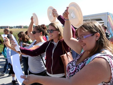 Stephanie Rempel, Kendra Edworthy and Cheyenne Weatherall look at the great North American solar eclipse through homemade pin-hole cameras on Monday, Aug. 21, 2017.