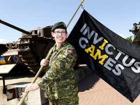 Rita Richter, Invictus Games Flagbearer, 41 Canadian Brigade Group Headquarters was presented the ceremonial Flag during the Invictus Games National Flag Tour  at the The Military Museums in Calgary. The Invictus Games National Flag Tour is traveling from coast-to-coast and will visit 22 Canadian Armed Forces, 15 legions and over 50 communities, from August 16th to September 22nd. Wednesday August 23, 2017. Darren Makowichuk/Postmedia