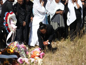 Mourners gather at the intersection of Hwy. 36 and Hwy. 570, 20 minutes south of Hanna, on Tuesday, Aug. 22, 2017. The vigil was held in memorial of an 11-month-old girl, an 11-year-old boy and a 16-year-old girl were travelling home to the United States with their parents. (Photo by Chelsea Kemp/Hanna Herald)