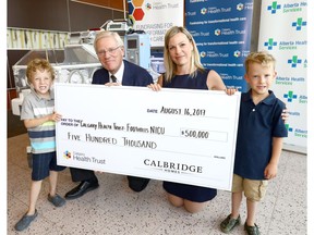 Twins, Emmett and Lucas Heynen,5, both brothers who needed neonatal intensive care, with Calgary Health Trust president and CEO Dr. Chris Eagle and president and CFO of Calbridge Homes, Bev Higham-Linehan as Calbridge Homes donates $500,000.00 to the neonatal intensive care unit (NICU) at Foothills Hospital.