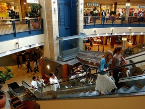 Shoppers ride escalator in Chinook Centre.