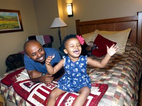 Timo Kaid and his daughter, Leila,1, have some fun at Ronald McDonald House during the opening of its newest family suite on Aug. 14, 2017.