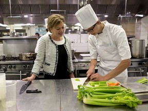 Summer Cooks student Travis Cornelius shows some of his kitchen skills to Andrea Rosgen, who represents The Joyce Family Foundation. The foundation contributed $2 million to SAIT's School of hospitality and Tourism.