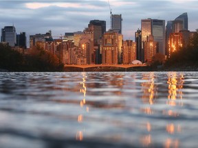 The dramatic Calgary skyline glows as clouds part right at sunset on an otherwise gloomy day Tuesday evening September 20, 2016. (Ted Rhodes/Postmedia)