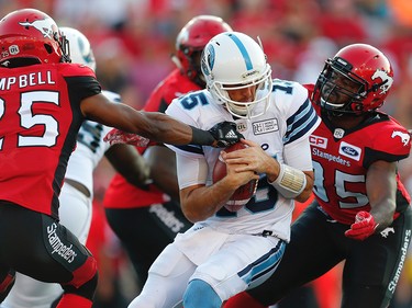 Calgary Stampeders Tommie Campbell and Ja'Gared Davis bring down quarterback Ricky Ray of the Toronto Argonauts during CFL football on Saturday, August 26, 2017. Al Charest/Postmedia