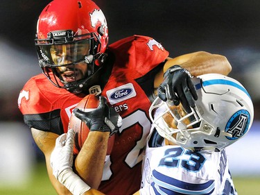 Calgary Stampeders Juwan Brescacin with a catch in front of Robert Woodson of the Toronto Argonauts during CFL football on Saturday, August 26, 2017. Al Charest/Postmedia