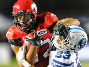 Calgary Stampeders Juwan Brescacin with a catch in front of Robert Woodson of the Toronto Argonauts during CFL football on Saturday, August 26, 2017. Al Charest/Postmedia