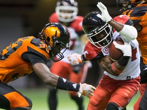 Calgary Stampeders' Roy Finch, right, tries to avoid the tackle by B.C. Lions' Chandler Fenner while returning a kick during the first half of a CFL football game in Vancouver, B.C., on Friday August 18, 2017. Darryl Dyck/The Canadian Press