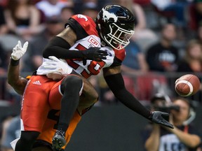 Calgary Stampeders' Jamar Wall (front) nearly intercepts a pass intended for B.C. Lions' Emmanuel Arceneaux during the first half of a CFL football game in Vancouver, B.C., on Friday August 18, 2017. Darryl Dyck/The Canadian Press