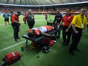 Calgary Stampeders' Jerome Messam is treated by a trainer on the sideline after leaving the field with an injury during the second half of a CFL football game against the B.C. Lions in Vancouver, B.C., on Friday August 18, 2017. Darryl Dyck/The Canadian Press